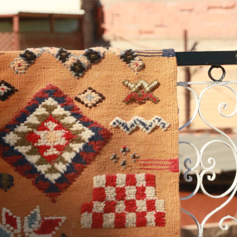 Handwoven Moroccan Akhnif flatweave rug with hand-embroidered geometric motifs