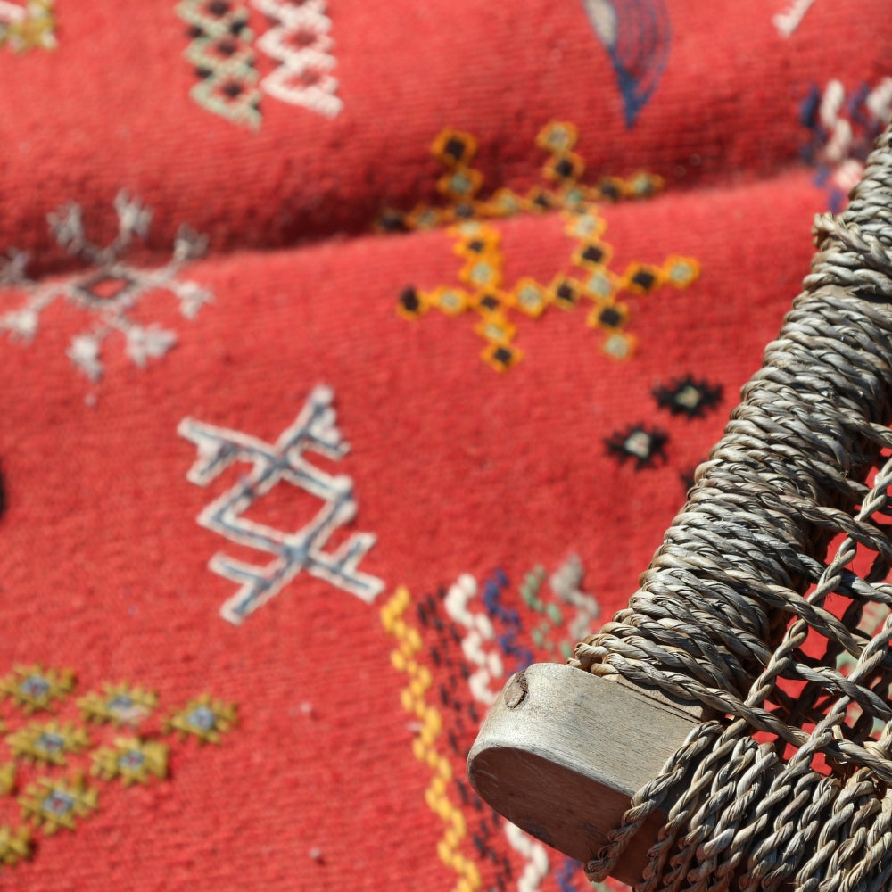 Handwoven Moroccan Aknif rug in deep red wool with embroidery details