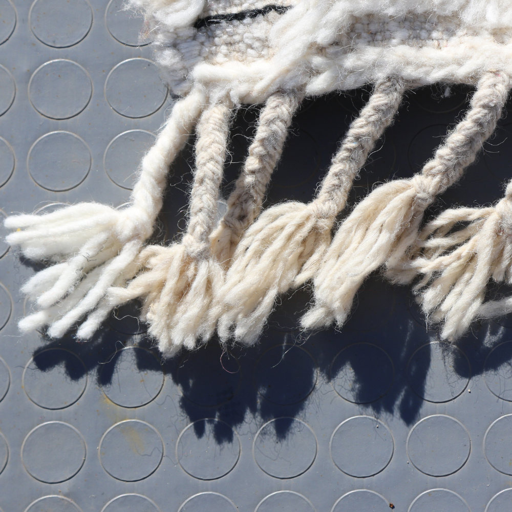 close up on a minimalist moroccan rug beni ourain ivory berber wool