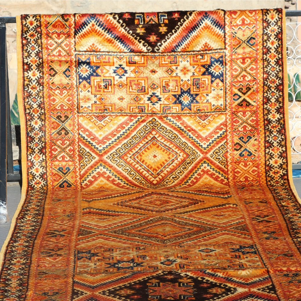 Handmade Moroccan Takznat rug with orange and black geometric patterns