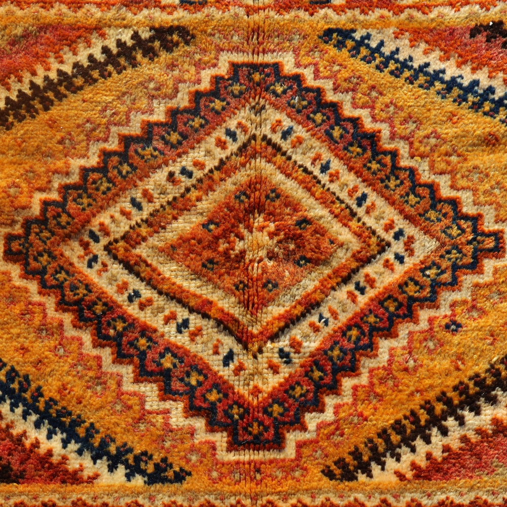 Detail of handmade Berber carpet showing rich orange tones