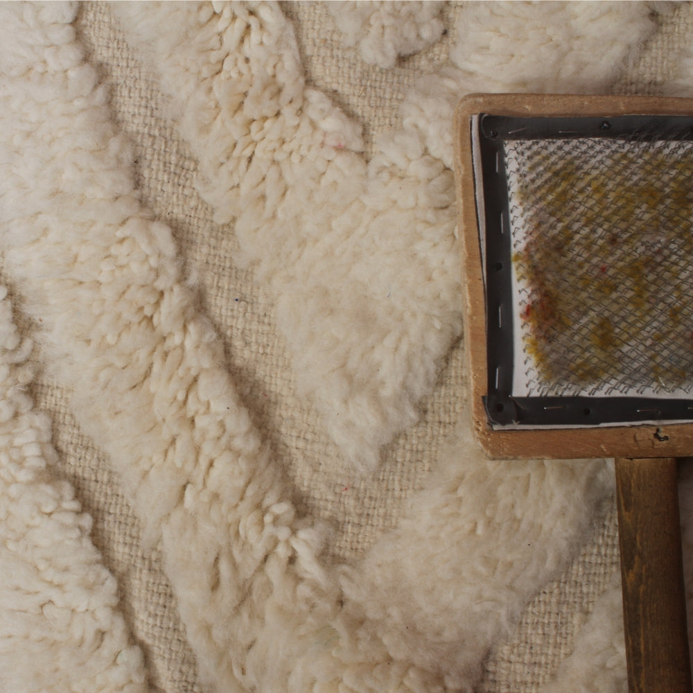 Close-up of textured fabric with a small brush or tool on top