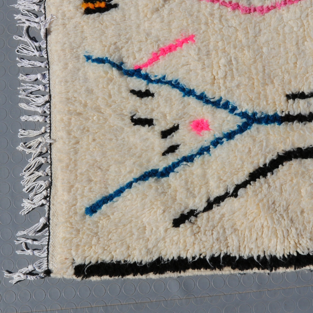 Detail of handwoven Azilal rug edge, thick ivory wool pile and traditional Moroccan craftsmanship