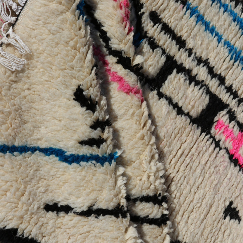 Close up of plush Moroccan wool rug, hand knotted Azilal pile with natural texture and artisanal finish