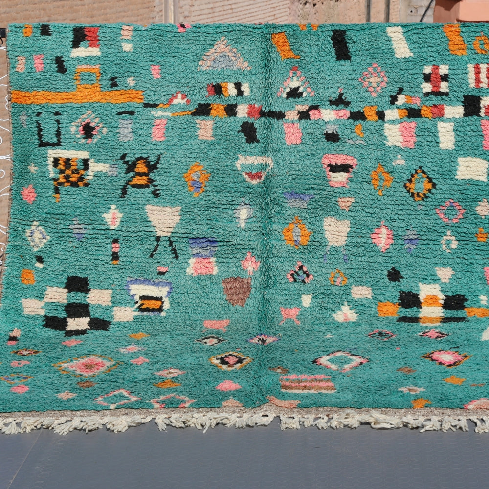 Azilal Berber rug handwoven in Morocco with turquoise wool and expressive geometric motifs