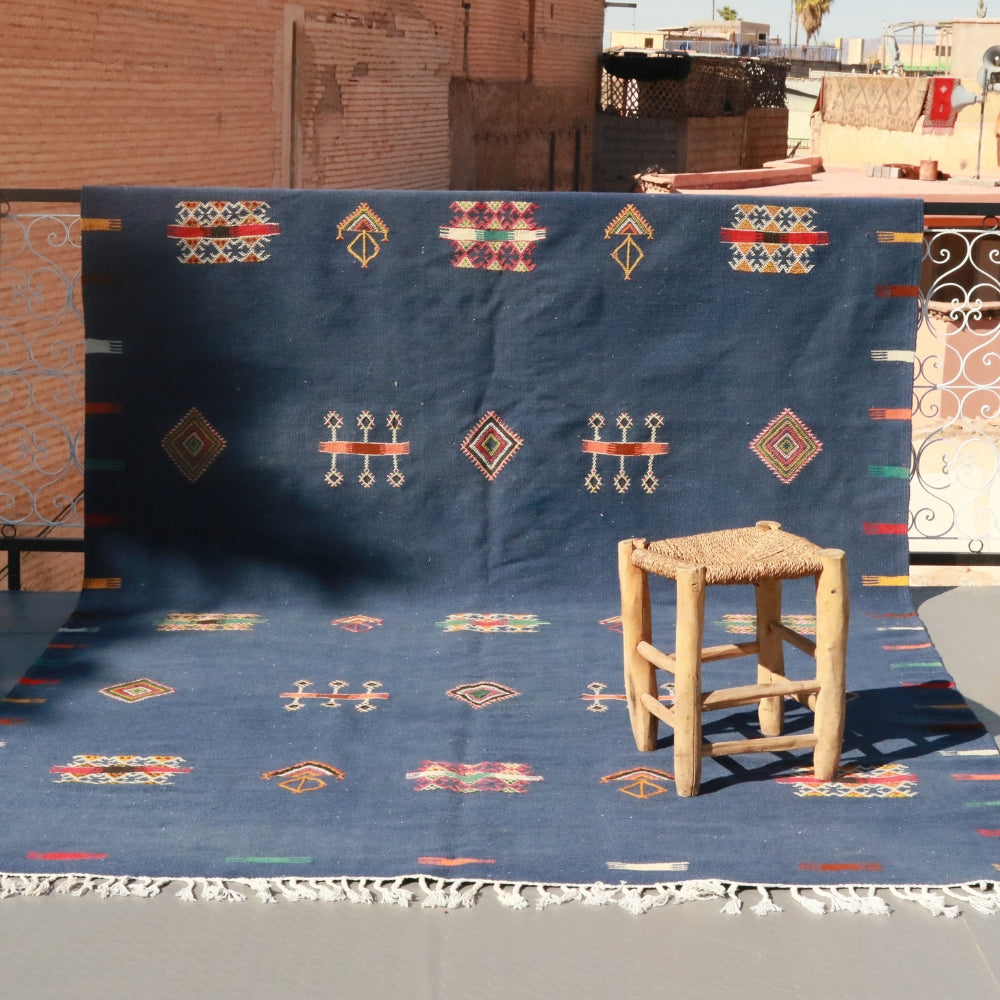 Aknif flatweave rug handwoven in Morocco with indigo wool and embroidered motifs