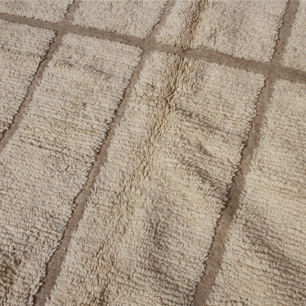 Close-up of textured minimal berber carpet with diamond pattern