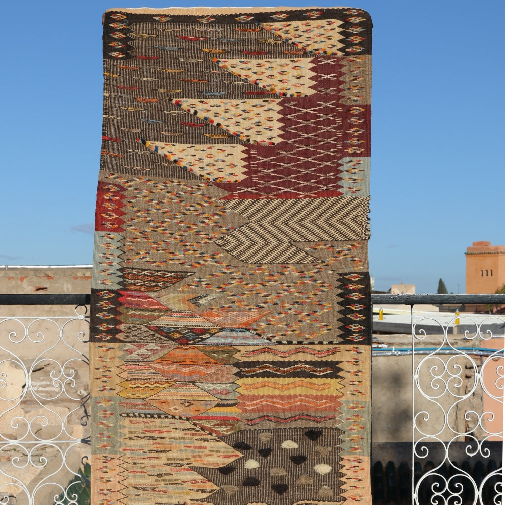 Handwoven Taznakht Berber rug displayed outdoors featuring abstract mosaic wool craftsmanship