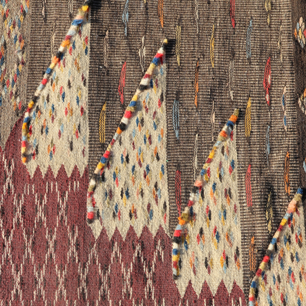 Detailed tribal motifs on Moroccan patchwork rug with intricate handwoven Berber wool texture