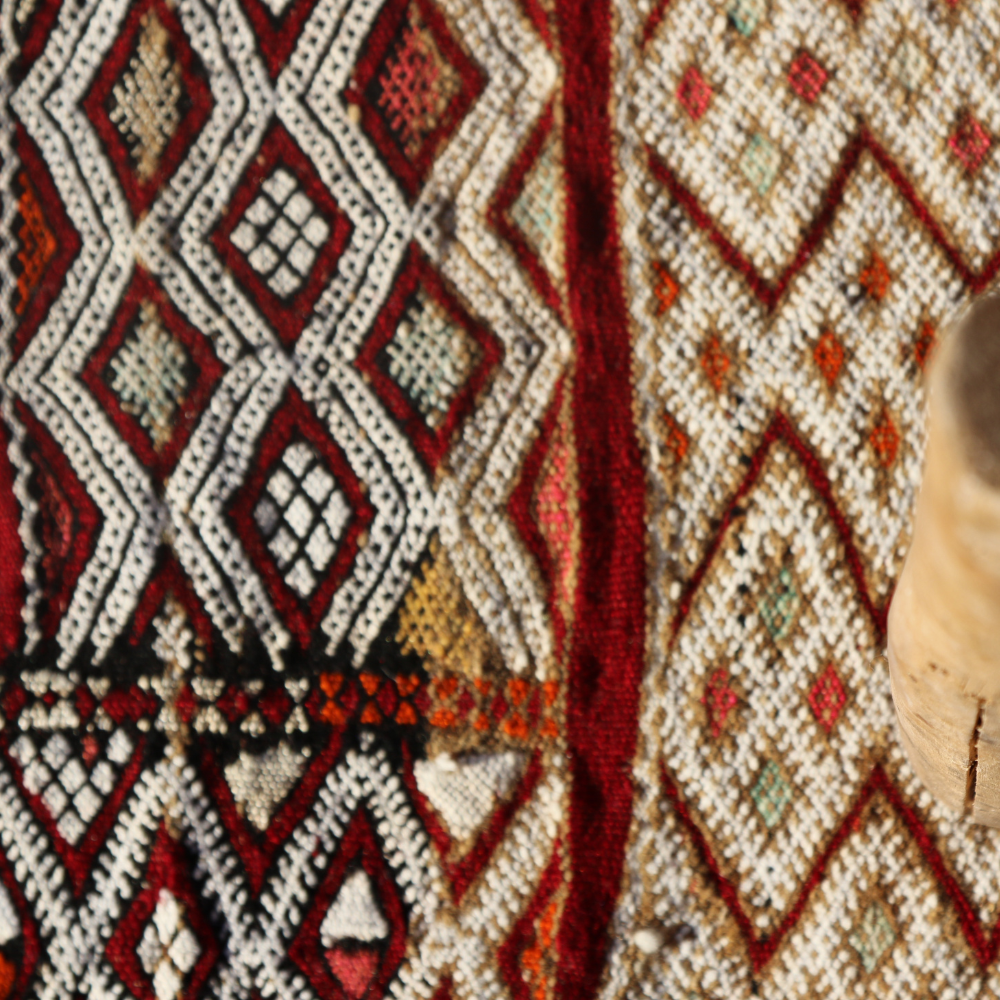 Close-up of Zamour Moroccan rug showcasing intricate geometric Berber weaving and artisan wool texture
