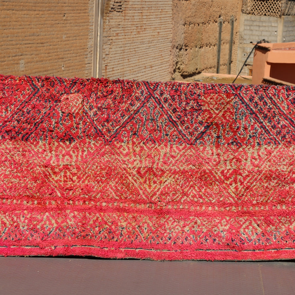Vintage Boujaad rug handwoven in Morocco deep red wool with geometric berber patterns and natural patina