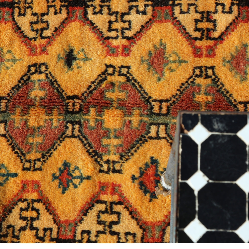 Close-up of vintage Tazenakht rug showing traditional Berber geometric symbols in handwoven wool