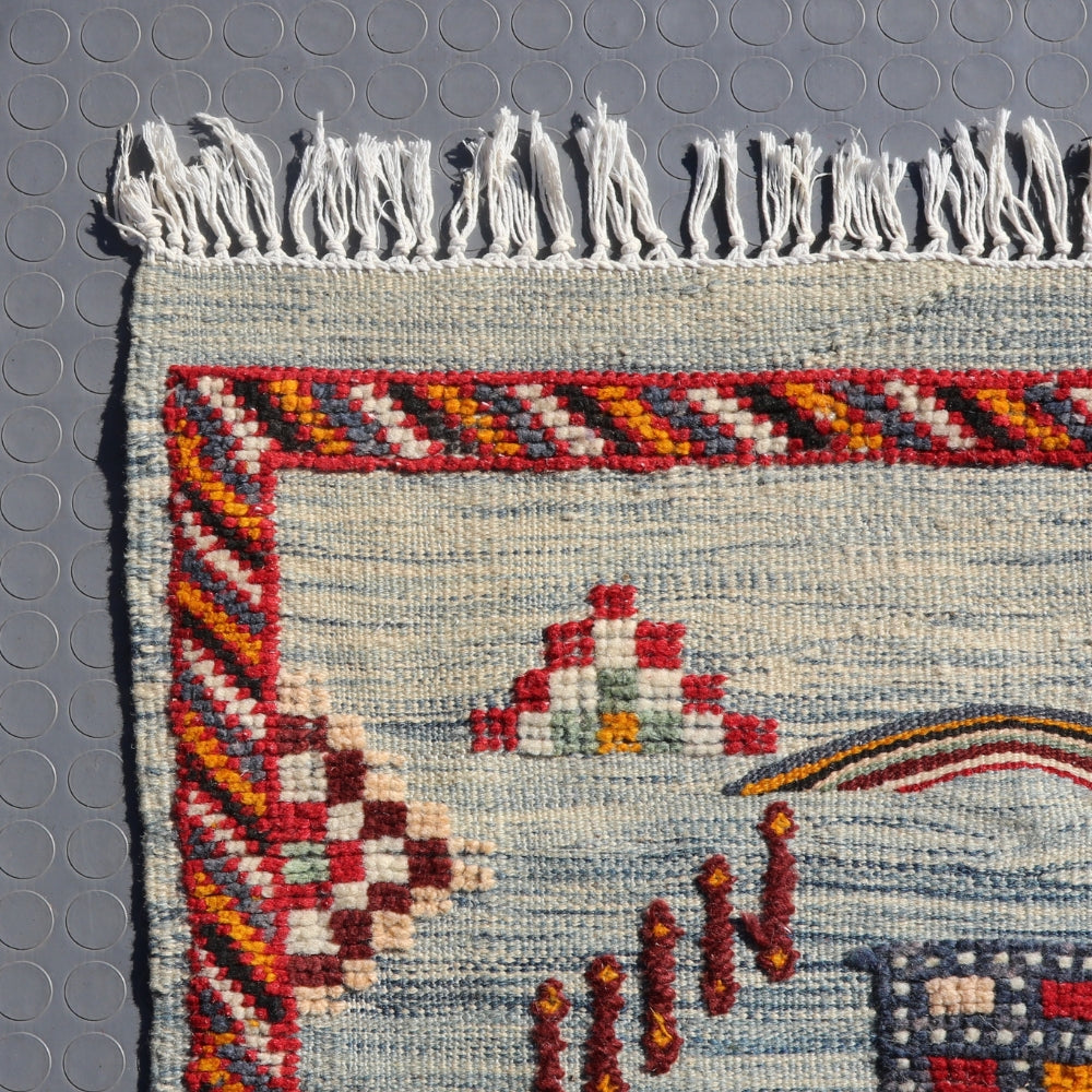 Detail of embroidered symbols on grey Moroccan Akhnif rug