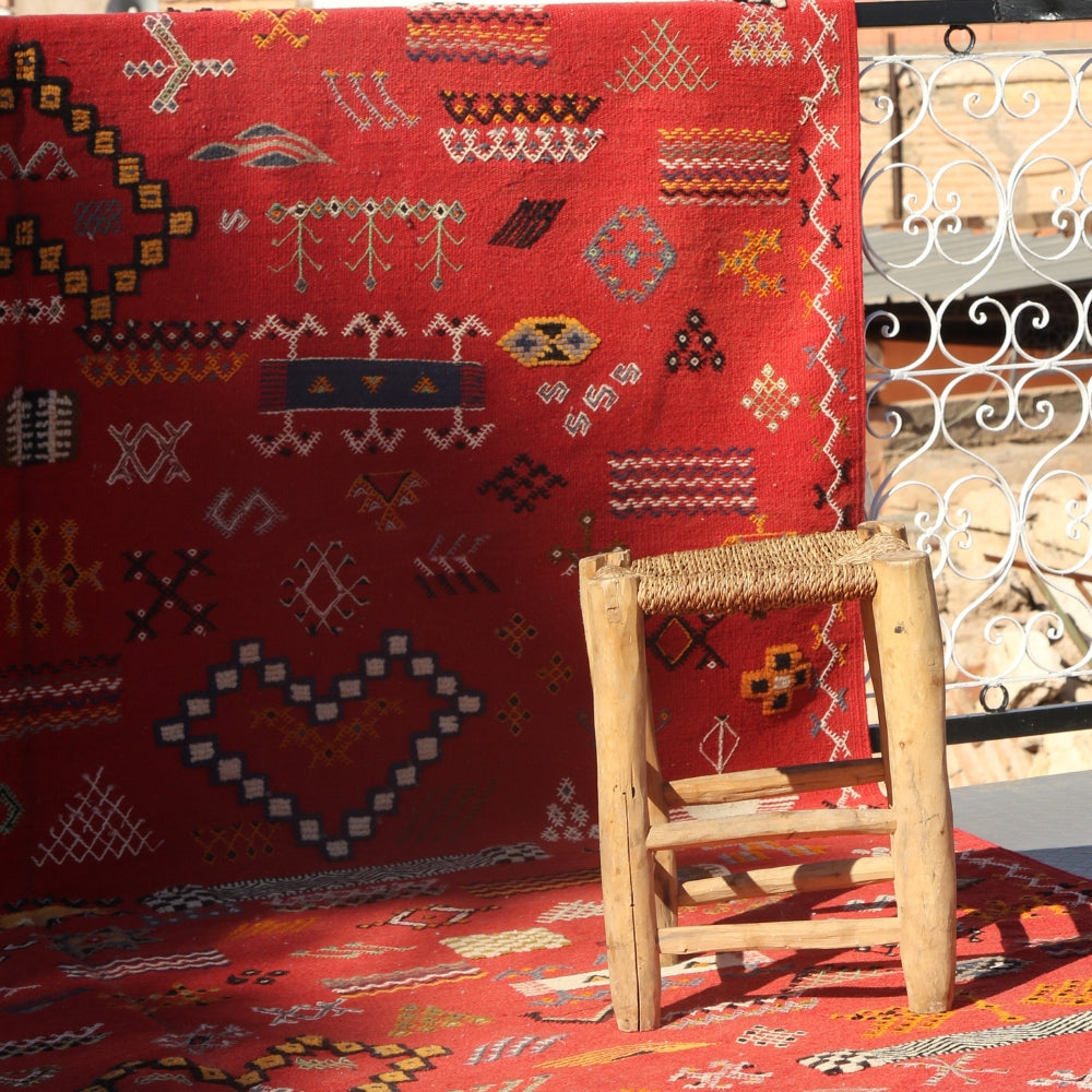 Red Moroccan Aknif flatweave rug with hand embroidered Berber motifs