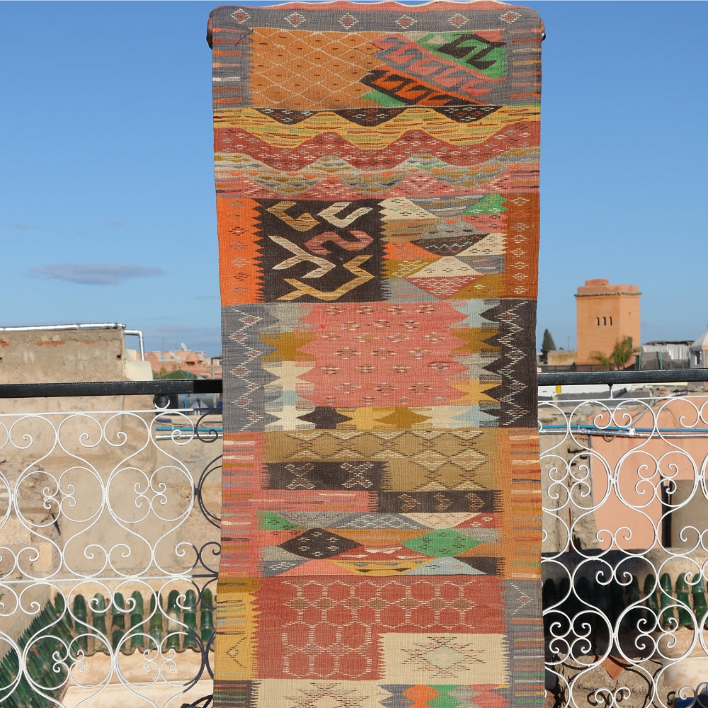 Close-up of colorful Taznakht Berber rug showcasing textured geometric Moroccan weaving