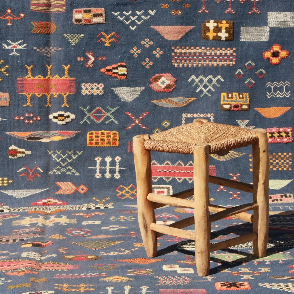 Aknif flatweave rug handwoven in Morocco with blue wool and embroidered Berber motifs