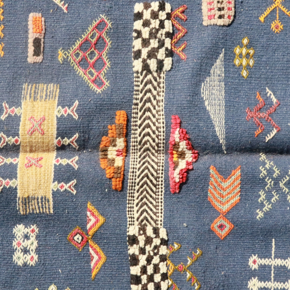 Close up of embroidered Berber symbols on Aknif flatweave wool rug