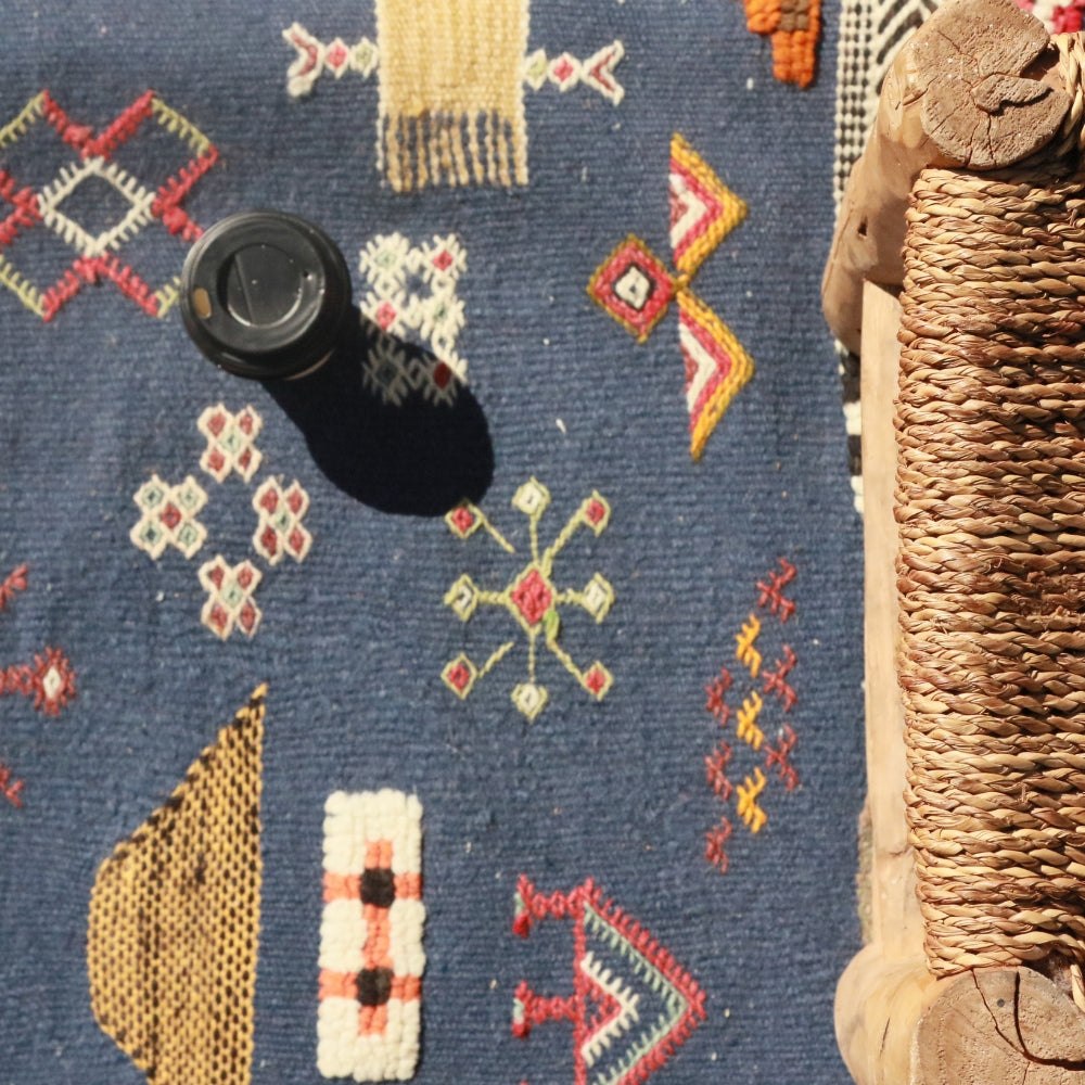 Minimalist Moroccan Aknif rug with handwoven flatweave and embroidery