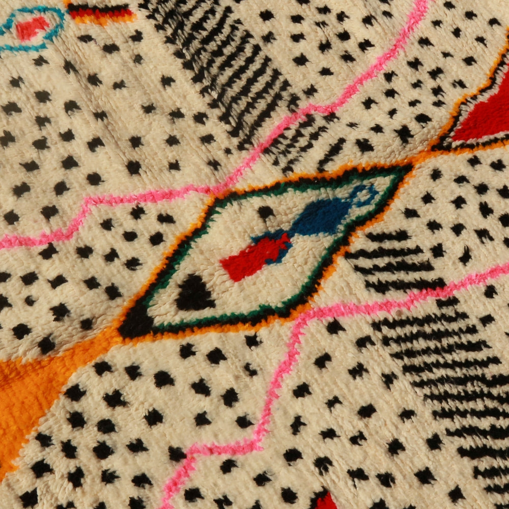 Moroccan Azilal wool rug with abstract patterns, ivory base and vibrant accents