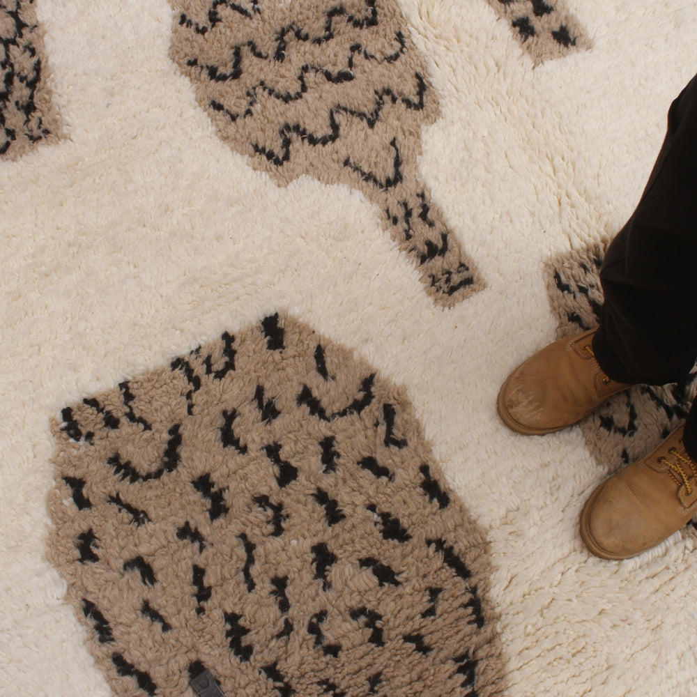 Patterned rug with animal print design on a neutral background