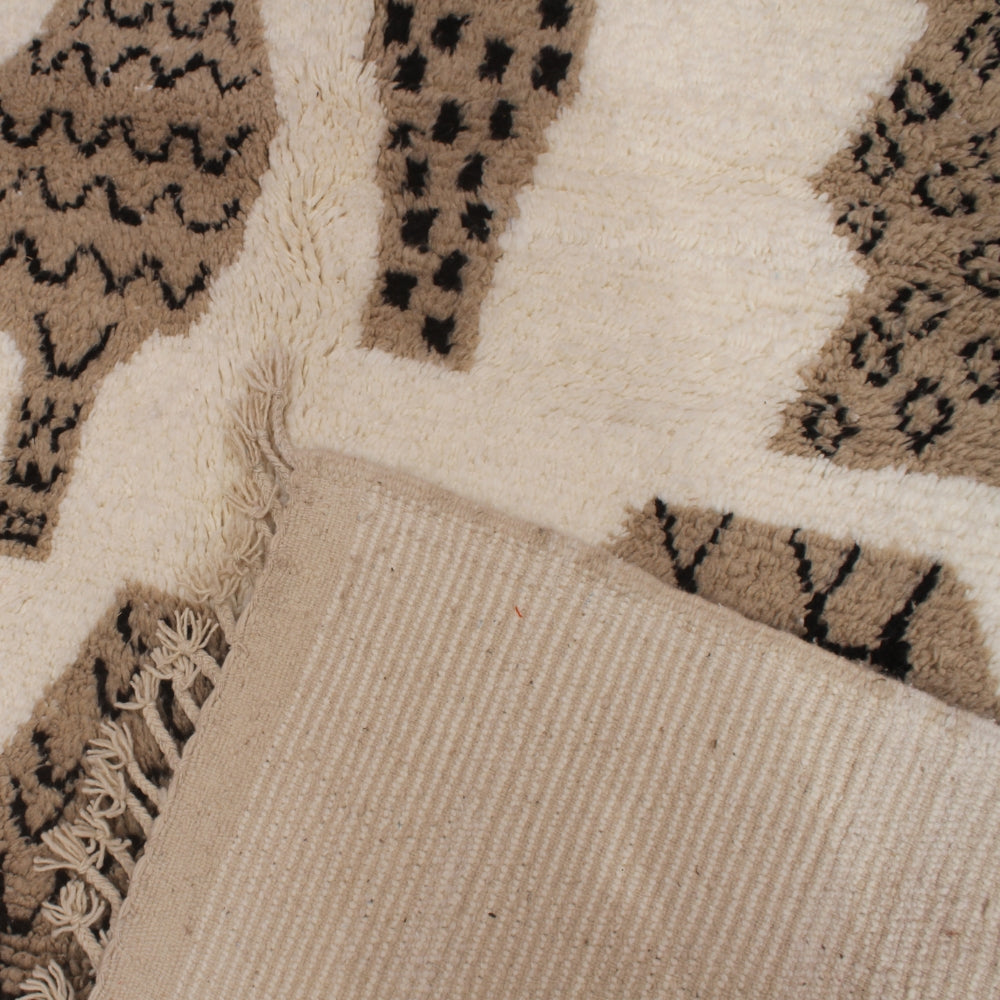 Minimalist Moroccan rug with black geometric motifs