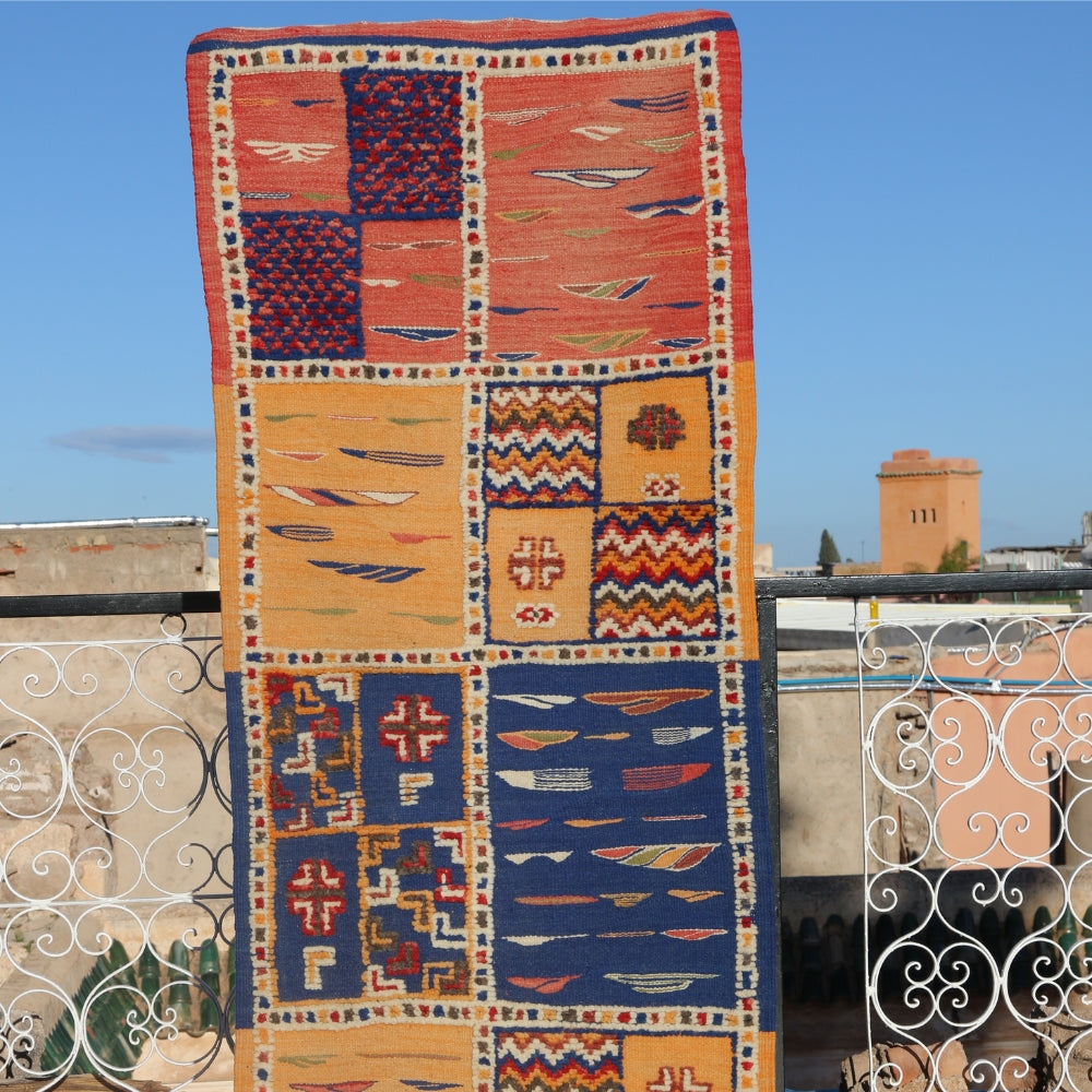 Handwoven Berber Picasso Moroccan rug displayed outdoors with abstract Taznakht patchwork design