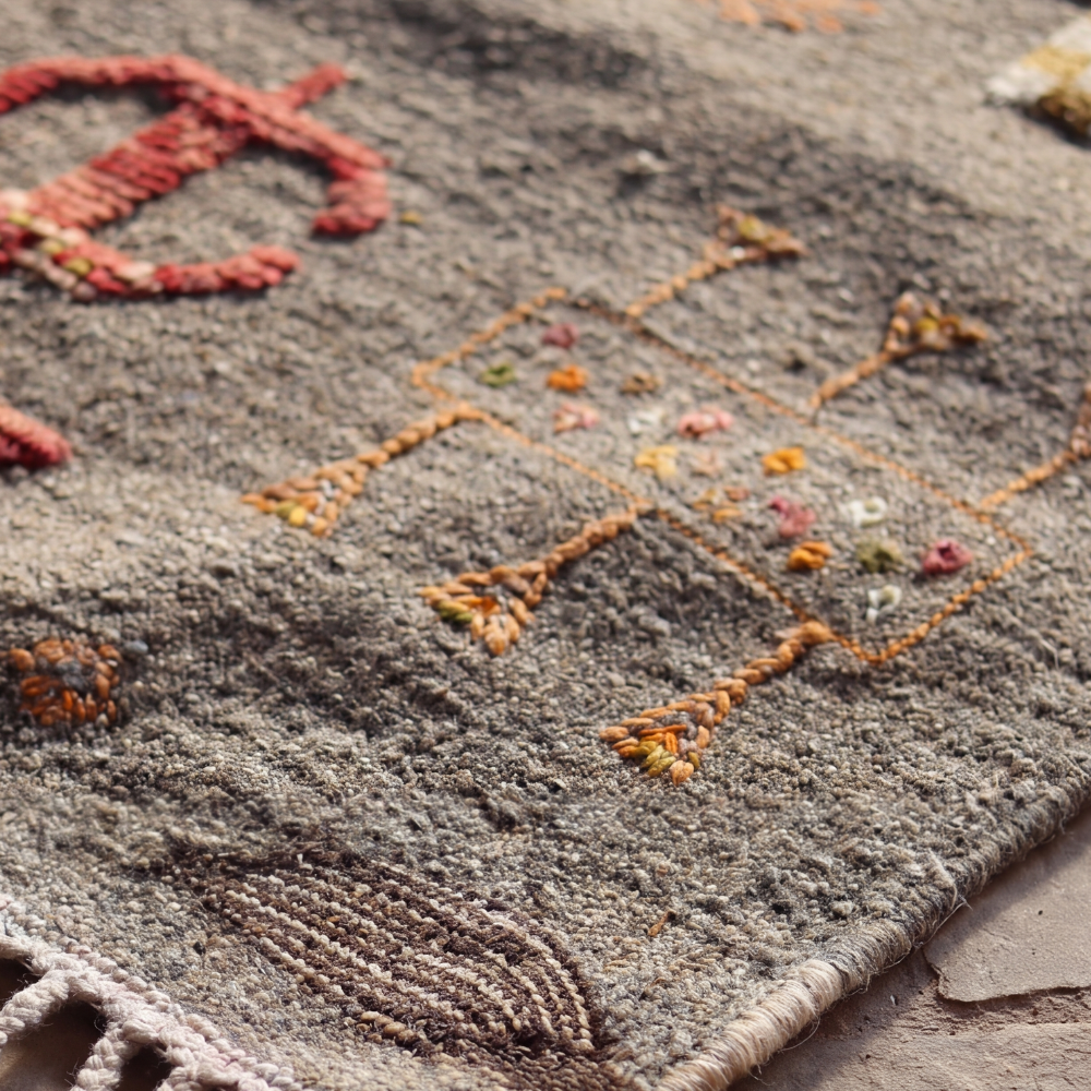 Macro detail of handwoven Akhnif rug highlighting textured Moroccan wool weaving