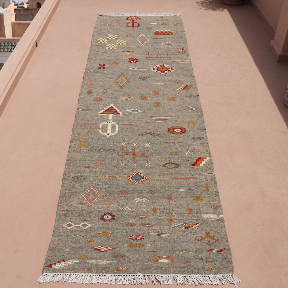 Long Moroccan Akhnif runner rug styled in minimalist adobe-inspired hallway interior