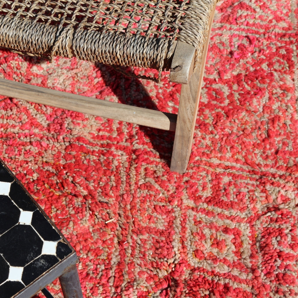 Close up of vintage Boujaad Moroccan rug handwoven wool with layered geometric motifs and aged texture